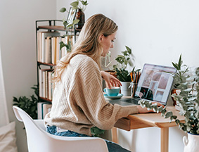 a woman sitting at a desk with a laptop